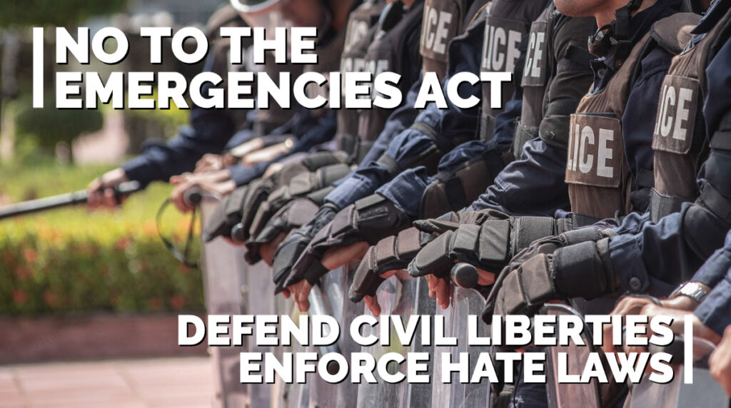 Riot police in background with text overlayed: "No to the Emergencies Act, Defend Civil Liberties, Enforce Hate Laws"