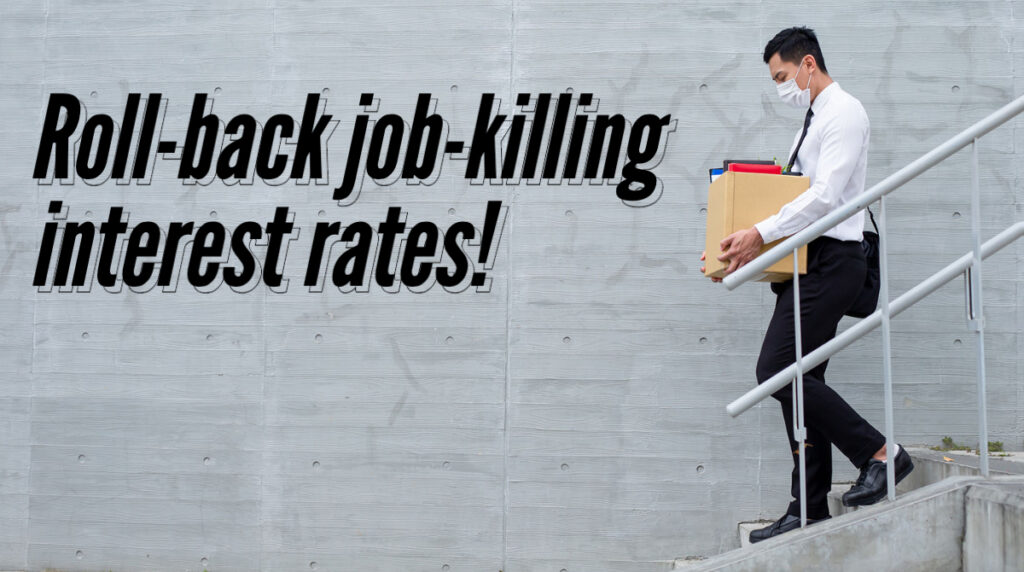 Laid off office worker with text "Roll-back job-killing intresest rates!"